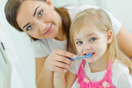 Mom and Daughter brushing their teeth - Pediatric Dentist in Temple Hills, MD, and Richmond, VA